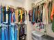 This is a walk-in closet with wire shelving filled with clothes on hangers and shelves at 3526 Warbler Way, Kissimmee, FL 34746