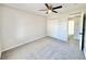 Bedroom with neutral carpet, double door closet, and adjacent hallway entrance at 3807 Mckinley Dr, Winter Haven, FL 33880