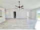 Bright living room featuring wood-look floors, ceiling fan, and neutral walls at 3807 Mckinley Dr, Winter Haven, FL 33880