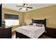 Bedroom with a ceiling fan, natural lighting, and a dark wood bedroom set at 3828 Eloise Estates Ct, Winter Haven, FL 33881