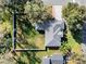 Overhead shot of a house with a gray roof, surrounded by a large, fenced backyard and mature trees at 4 Lake Eloise Ln, Winter Haven, FL 33884