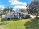 Beautifully landscaped front lawn accentuates the home's appealing facade at 4 Lake Eloise Ln, Winter Haven, FL 33884