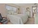 Bedroom with a cozy reading chair next to a window with natural lighting at 400 El Camino Dr # 101, Winter Haven, FL 33884