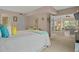 Comfortable bedroom with view into the living room, complete with quaint decor at 400 El Camino Dr # 101, Winter Haven, FL 33884