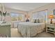Bright bedroom featuring dual windows, a writing desk, and neutral walls at 400 El Camino Dr # 101, Winter Haven, FL 33884