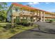 Multi-Gathering apartment with a red tile roof, mature landscaping, and ample parking at 400 El Camino Dr # 101, Winter Haven, FL 33884