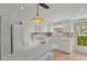 Well-lit white kitchen with stainless steel appliances and a convenient breakfast bar at 400 El Camino Dr # 101, Winter Haven, FL 33884