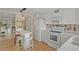 An open concept white kitchen with a modern range and bright, clean design at 400 El Camino Dr # 101, Winter Haven, FL 33884