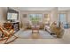 Bright living room with tile floors, comfortable seating, and a TV at 400 El Camino Dr # 101, Winter Haven, FL 33884