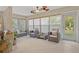 Comfortable sunroom with tile floors, ceiling fans, and a view of the landscaped backyard at 400 El Camino Dr # 101, Winter Haven, FL 33884