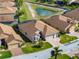 Aerial shot featuring a home with a screened pool, complemented by lush greenery at 4033 Phoenician Way, Winter Haven, FL 33884