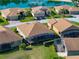 Captivating aerial shot shows backyard patio, complemented by a pool in a landscaped backyard at 4033 Phoenician Way, Winter Haven, FL 33884