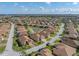 Sweeping aerial view featuring home with pond, golf course, and other neighborhood properties at 4033 Phoenician Way, Winter Haven, FL 33884