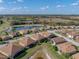 Charming home featuring a screened lanai, surrounded by lush landscaping and a serene lake at 4033 Phoenician Way, Winter Haven, FL 33884