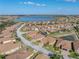 Picturesque aerial view captures the home's serene setting near a beautiful lake with lush landscaping at 4033 Phoenician Way, Winter Haven, FL 33884