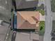 Birds-eye view of a home showcasing roof, backyard with a pool and a brick driveway at 4033 Phoenician Way, Winter Haven, FL 33884