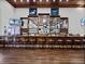 Stylish Lake Ashton clubhouse bar with wooden accents, mirrored details, and ample seating at 4033 Phoenician Way, Winter Haven, FL 33884