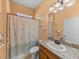 Bathroom with shower-tub combo, decorative shower curtain, and granite countertop at 4033 Phoenician Way, Winter Haven, FL 33884