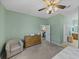 Spacious bedroom features a sitting chair, dresser and ensuite bathroom access at 4033 Phoenician Way, Winter Haven, FL 33884