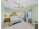 Comfortable bedroom with ceiling fan, window with curtains, and two nightstands at 4033 Phoenician Way, Winter Haven, FL 33884