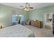This bedroom features a large window, sitting chair, and ensuite bathroom access at 4033 Phoenician Way, Winter Haven, FL 33884