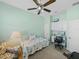 Cozy bedroom with large window, chair, ceiling fan, and built-in desk at 4033 Phoenician Way, Winter Haven, FL 33884