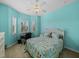 Bright bedroom with turquoise walls, plantation shutters, and ceiling fan at 4033 Phoenician Way, Winter Haven, FL 33884