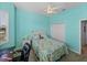 Bright bedroom with turquoise walls, plantation shutters, ceiling fan, and closet at 4033 Phoenician Way, Winter Haven, FL 33884