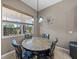 Dining area with a window and outdoor view, a modern chandelier, and seating for four at 4033 Phoenician Way, Winter Haven, FL 33884