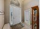 Bright foyer with a large front door, sidelights, tile flooring, and an open floor plan at 4033 Phoenician Way, Winter Haven, FL 33884
