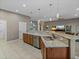A large open kitchen has stainless steel appliances and plenty of cabinets at 4033 Phoenician Way, Winter Haven, FL 33884