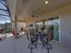 Entertain on this spacious covered lanai with seating, outdoor kitchen area, and serene backyard views at 4033 Phoenician Way, Winter Haven, FL 33884