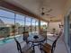 Dine and relax on this spacious covered lanai with comfortable seating and serene backyard views at 4033 Phoenician Way, Winter Haven, FL 33884