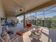 Entertain on this spacious covered lanai with seating, outdoor kitchen, and serene backyard views at 4033 Phoenician Way, Winter Haven, FL 33884