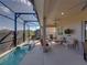 Entertain on this spacious covered lanai with seating, outdoor kitchen area, and serene backyard views at 4033 Phoenician Way, Winter Haven, FL 33884