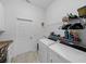Convenient laundry room complete with washer, dryer, and sink at 4033 Phoenician Way, Winter Haven, FL 33884
