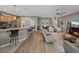 An open-concept floor plan connects the kitchen to the living area with a ceiling fan and wood floors at 4033 Phoenician Way, Winter Haven, FL 33884