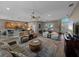 Spacious living room with an open floor plan, ceiling fan, and wood-look tile flooring at 4033 Phoenician Way, Winter Haven, FL 33884