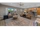 Bright living room featuring a sliding glass door, wood-look flooring, and comfortable seating at 4033 Phoenician Way, Winter Haven, FL 33884