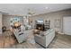 Open-concept living room with dining area, fireplace, neutral colors, and ample seating at 4033 Phoenician Way, Winter Haven, FL 33884
