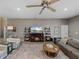 Cozy living room with a decorative rug, a ceiling fan, a fireplace, and ample seating at 4033 Phoenician Way, Winter Haven, FL 33884