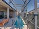 Long, narrow, screened-in pool area with an outdoor seating and lounging area including a sofa at 4033 Phoenician Way, Winter Haven, FL 33884