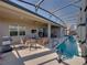 Relaxing screened-in patio and pool area featuring stylish furniture, ceiling fan and a clear view of the inviting, narrow pool at 4033 Phoenician Way, Winter Haven, FL 33884