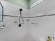 Modern shower featuring white tiles and a black showerhead at 4033 Phoenician Way, Winter Haven, FL 33884