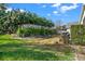 Landscaped backyard featuring lush greenery, trees, and a charming fence, perfect for outdoor relaxation at 428 Lake Suzanne Dr, Lake Wales, FL 33859