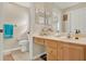 Bathroom featuring vanity with drawers and a sink, toilet, and large mirror at 428 Lake Suzanne Dr, Lake Wales, FL 33859