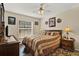 Bedroom with a patterned rug, wood furniture, and a window at 428 Lake Suzanne Dr, Lake Wales, FL 33859