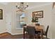 Eat-in kitchen dining area with a chandelier and hardwood flooring at 428 Lake Suzanne Dr, Lake Wales, FL 33859