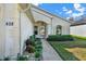 Charming home with lovely front garden leading to front door and windows with awnings at 428 Lake Suzanne Dr, Lake Wales, FL 33859