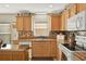 Well-lit kitchen with tiled backsplash, stainless steel sink and modern appliances at 428 Lake Suzanne Dr, Lake Wales, FL 33859